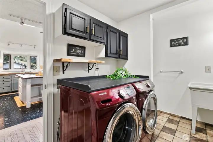 Laundry room right off the kitchen with a door out to the garage.  There is a 1/2 bath in here also.