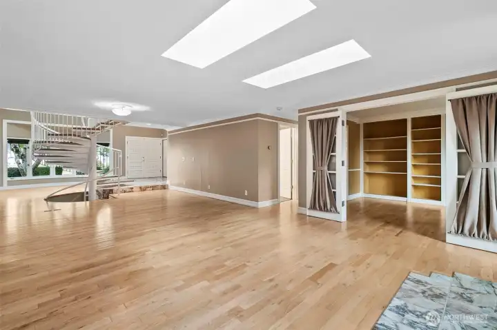 Looking towards the entry way, den and hallway to the 2nd den and primary bath.