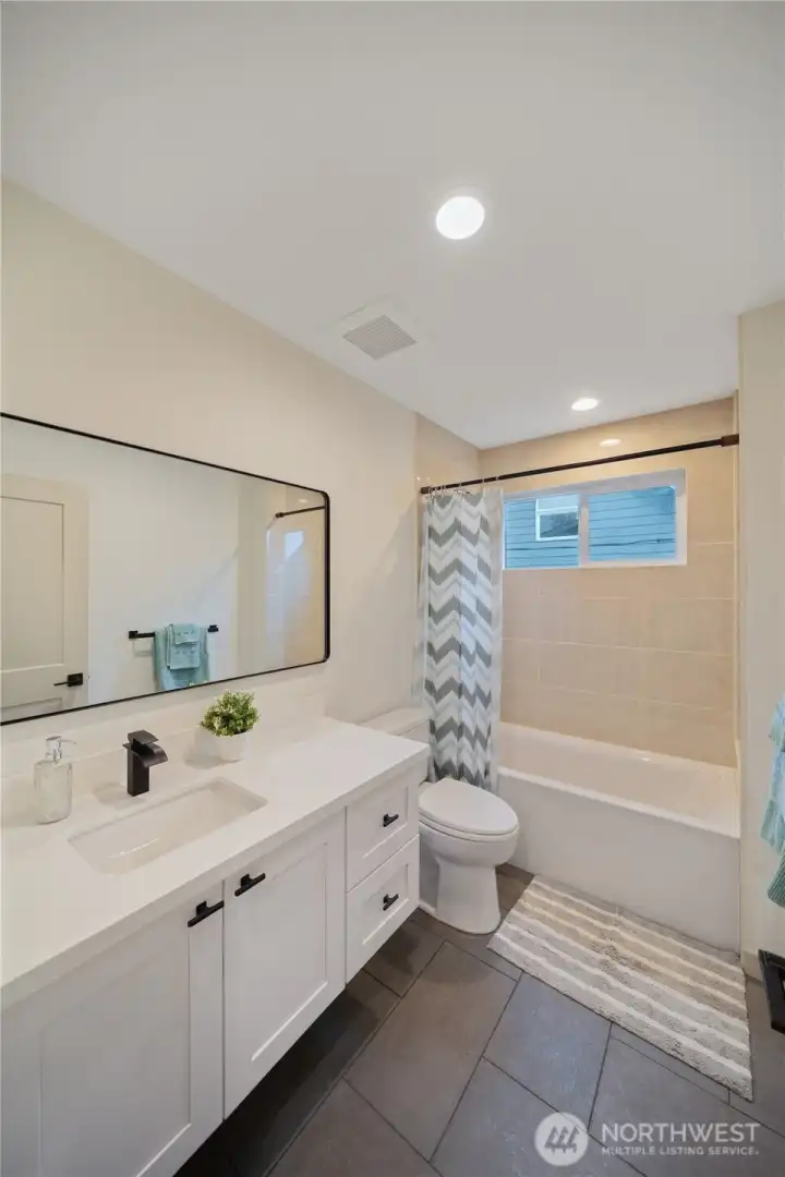 Main Bathroom with Tile througout and floating vanity