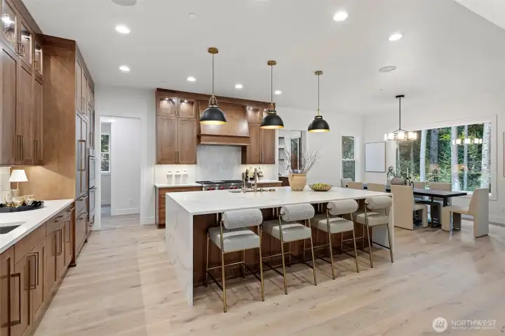 Stunning and Grand! This waterfall-edge island with Quartz Slabs is a show stopper.