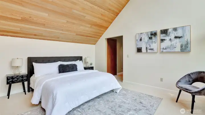 The spacious primary suite on the upper level offers more eye catching wood lined vaulted ceilings, a walk-in closet, two additional closet, and an attached ¾ bath.