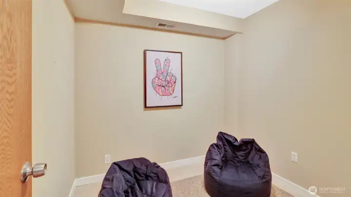 Cozy flex space on the lower-level us ideal for a home office, reading nook, play space, or creative corner.