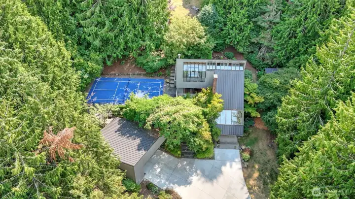 Aerial view showcase this exceptional property with a private pickleball court.