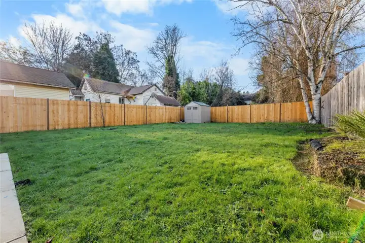 Concrete walkway wraps from front to back yard