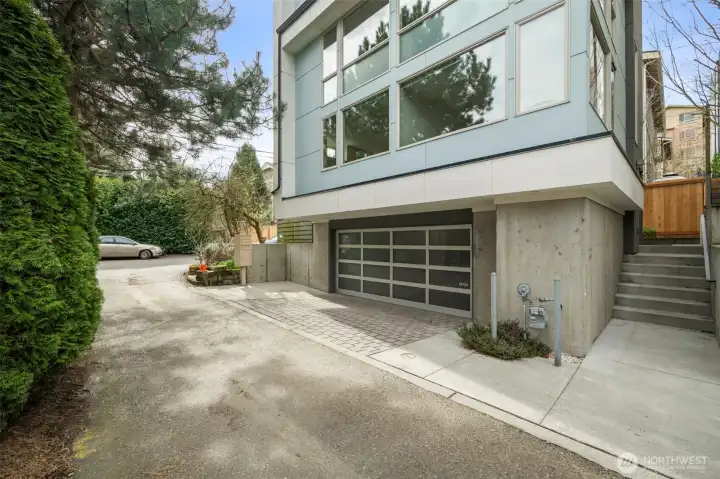 Sited atop a 540 sf 2-car garage. Yes, that's a parking space out front as well.