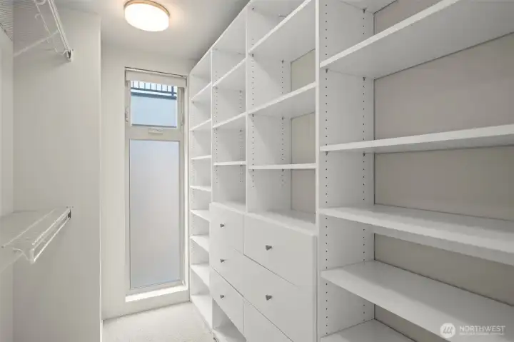 Walk-in closet with floor-to-ceiling window for natural light