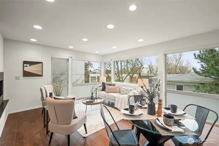 Wall of windows surrounds the living room and kitchen