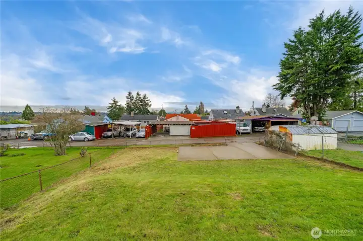 Large back yard with alley access and parking slab.