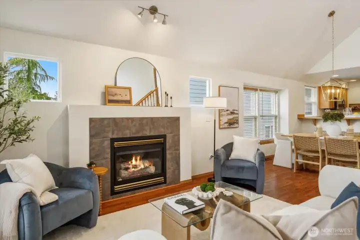 Abundant windows bring in natural light, creating a bright, open feel that connects the living, dining, and kitchen spaces.