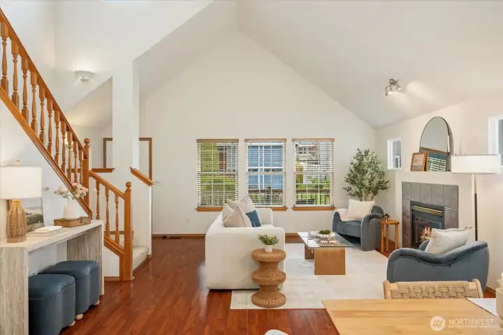 Massive, soaring vaulted ceilings span the living and dining areas, creating an immediate sense of openness and light.