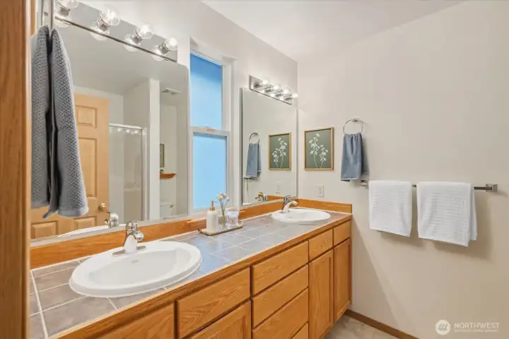 Luxurious en-suite featuring an expansive double vanity and generous proportions, this space is designed for a seamless, unhurried start to your day.