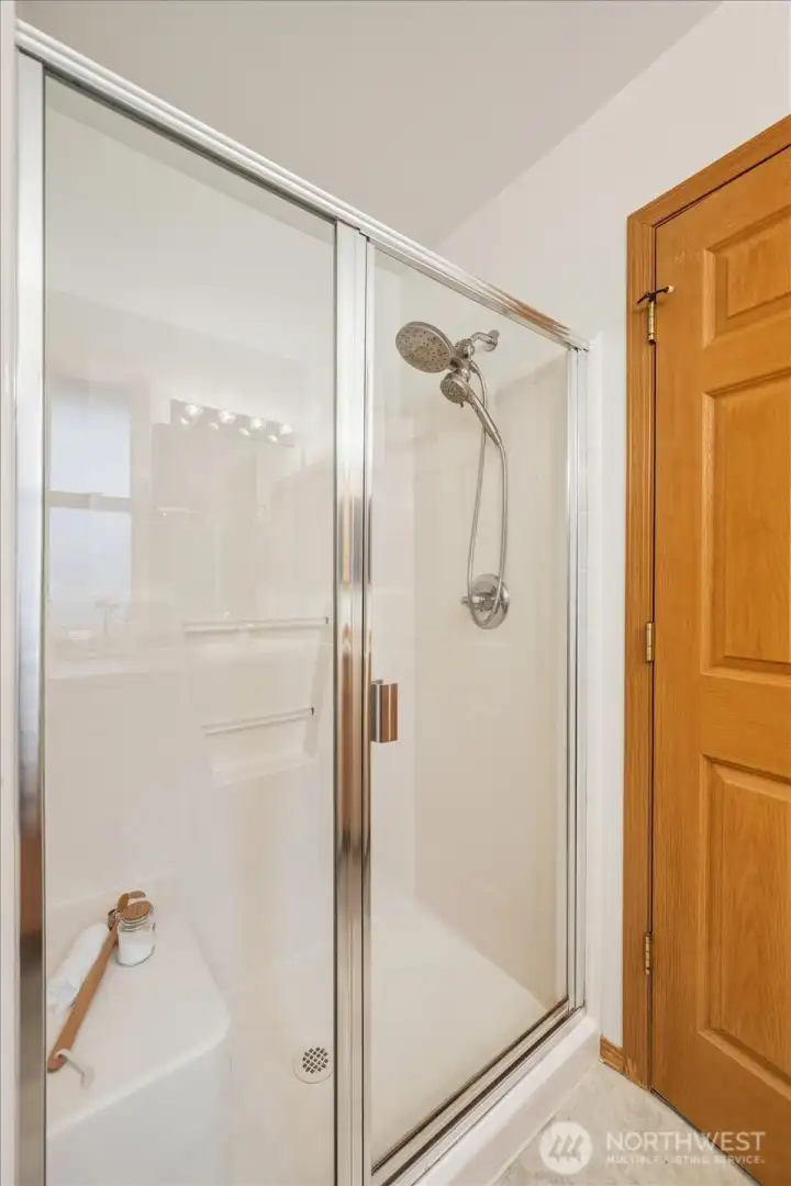 A bright and functional walk-in shower within the primary bath.