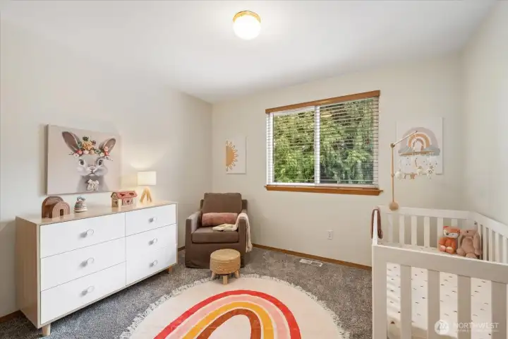 A bright secondary bedroom on the main-level ideal for guests, a home office, or a personalized space to fit your needs.