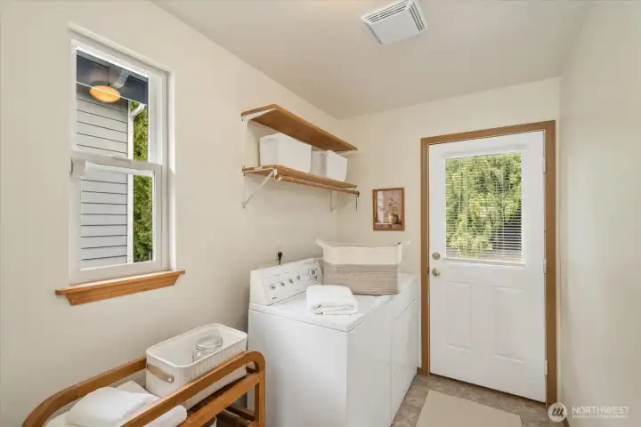 Spacious main-level utility room with washer and dryer included for a seamless, turnkey transition. Large enough to fit a utility sink as well!