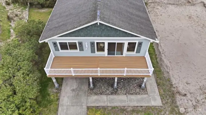 Look at this nice, newer trex deck that spans the entire front of the home~
