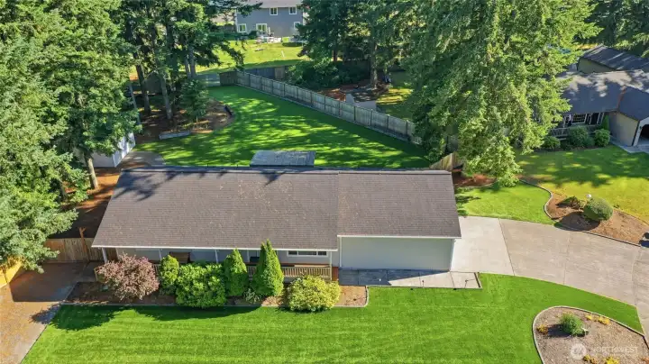 Covered front & back porches- oversized garage & Shop with RV Parking too!  Plenty of space - and NO MOWING! That's ASTRO TURF - front & back!