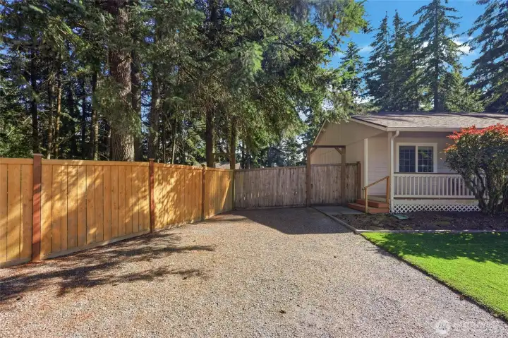 Gate to the left of the Covered Front Porch- fully Fenced Back Yard.  Clean as a Whistle!