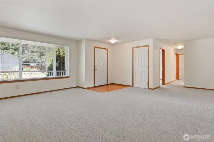 Front door to left- that's the coat closet, 6 panel door and a leek into the dining area.  One year old carpets will be cleaned on the 24th.