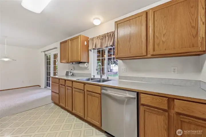 View of the Kitchen on the right- Window overlooks the backyard.
