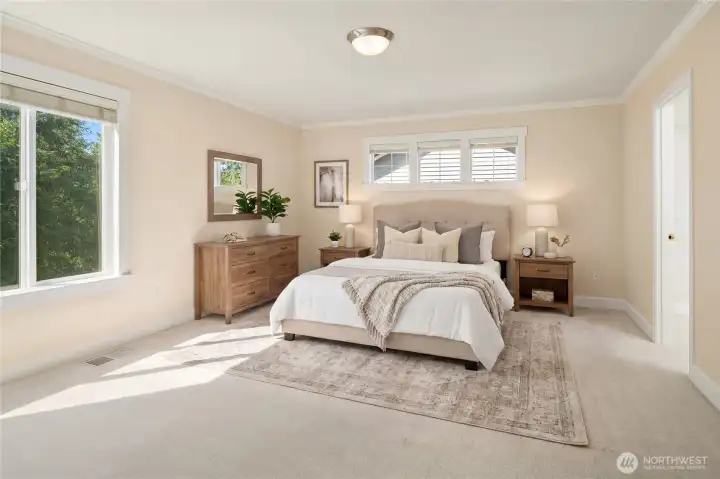 Room is virtually staged. The spacious primary suite features an ensuite bathroom and a walk-in closet.