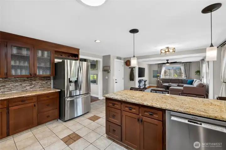 Glass front cabinetry, a wine rack and the newer, included French door refrigerator plus updated stainless appliances are a few more of the great features in this charming kitchen