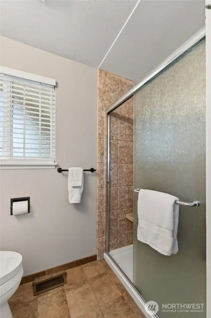 Such a roomy shower and there is a linen close located to the right