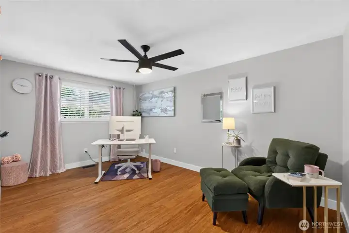 One of 2 more big bedrooms with hardwood flooring and a new ceiling fan light.