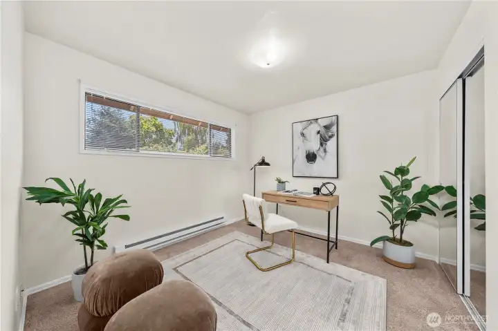 1 of 2 bedrooms on the main level - staged as an office but room does have a closet. 1 of 2 bedrooms on the main level - staged as an office but room does have a closet.