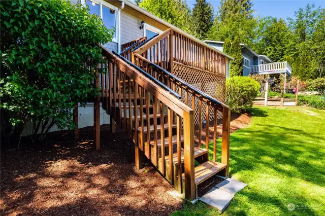 Stairs from the back deck lead to the backyard.
