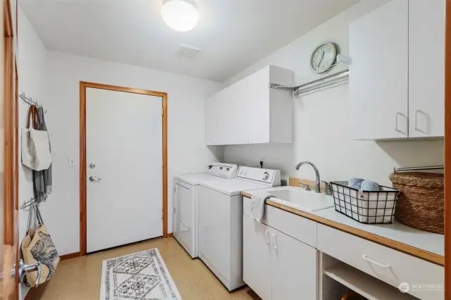 Laundry with sink off garage and kitchen.