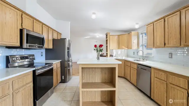 This well-appointed kitchen features quality quartz countertops, tile backsplash, ceramic tile flooring, matching Samsung stainless steel appliances, abundant cabinet storage space, and versatile center island!