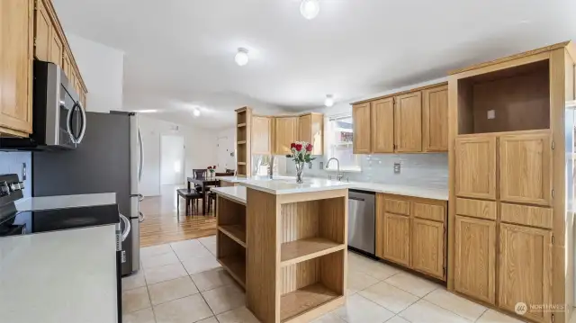 You won't feel crowded in this kitchen where's plenty of room between the cabinets and center island!