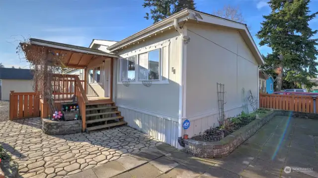 Inside the fully fenced side yard you'll find low maintenance stamped concrete walkway, concrete tiles, and raised planting beds.