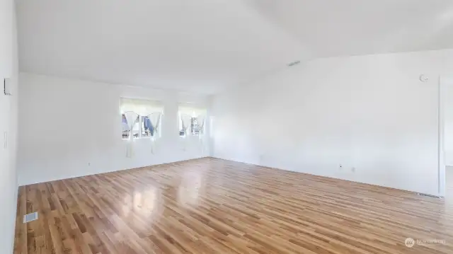 The living room, as well as the primary suite, bedrooms and bonus room, have these gorgeous and durable engineered hardwood flooring!