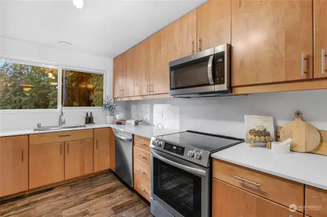 Kitchen features plenty of cabinets and counterspace plus a pantry.