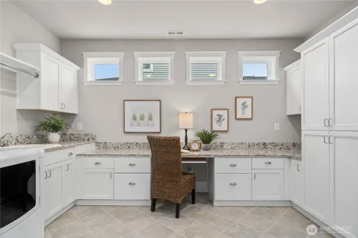 The popular Smart Space is a laundry, craft, office or whatever you need it to be!  Quartz counters, tile floors, tons of storage and a handy utility sink.