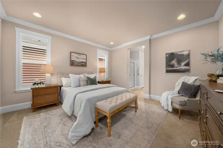 Primary bedroom with beautiful trim work, crown molding and beautiful Plantation shutters.