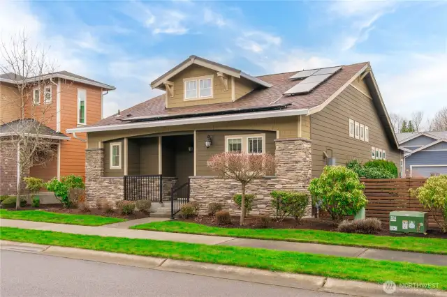 Extensive stone, a cute front porch, extra wide space between neighbors and solar panels!