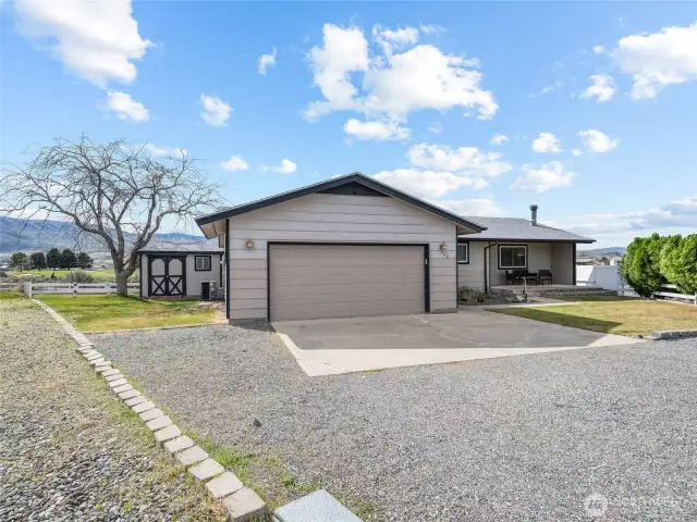 Front of home with small storage shed.