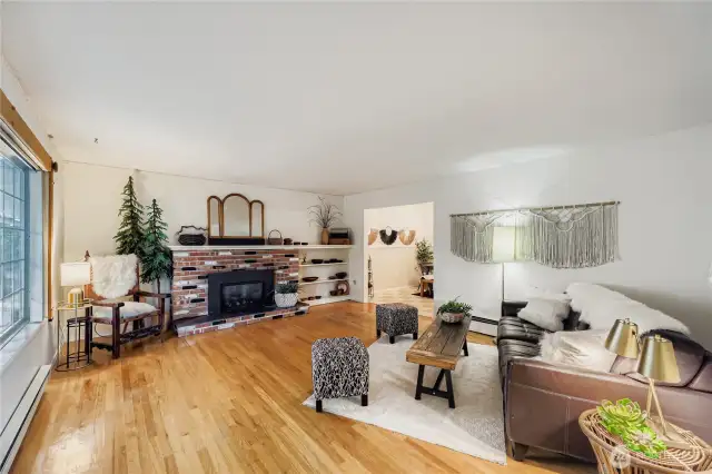 Cozy living area anchored by a brick fireplace with built-in shelving, offering warmth and charm for gatherings.