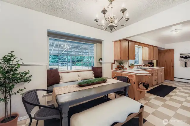 Dining nook with backyard views, just steps from the kitchen—ideal for everyday meals or entertaining."
