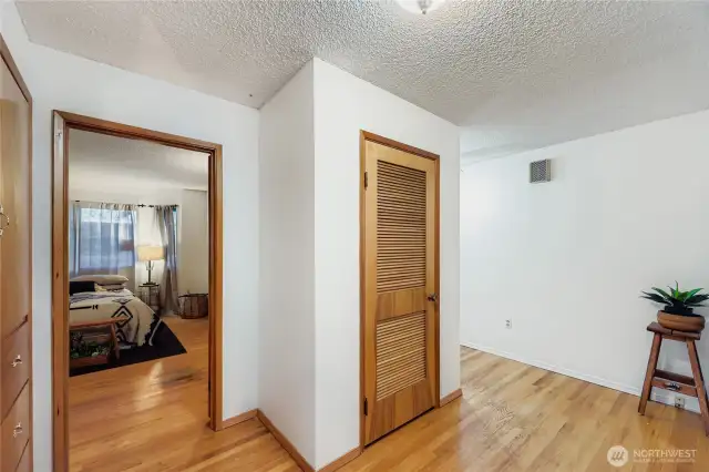 Hallway with hardwood floors and easy access to bedrooms and bath.