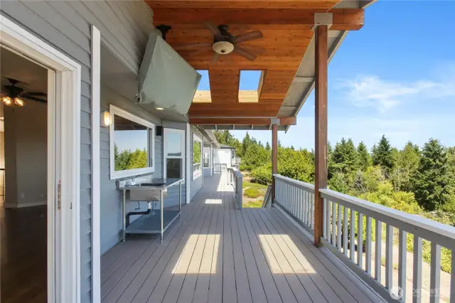 Upstairs deck has a TV mounted and ceiling fan for year round entertainment and comfort