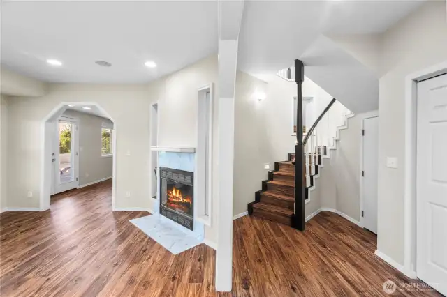 Downstairs opens to a hallway, family room/den space, and SO MUCH STORAGE SPACE
