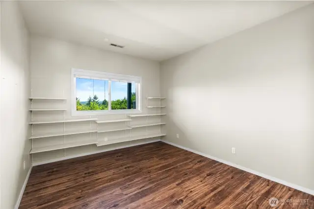Downstairs bedroom 1 with built-in shelving unit