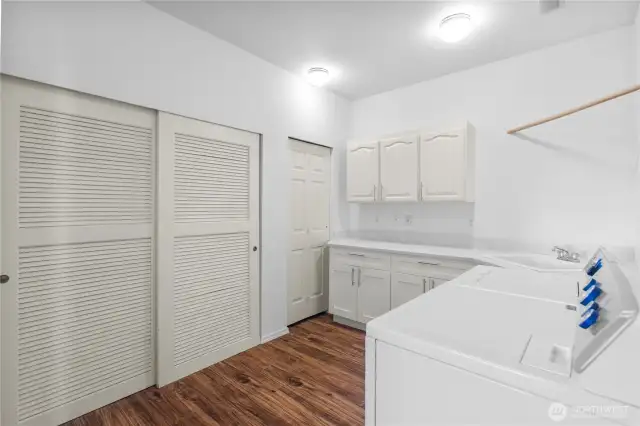 HUGE utility room with TONS of storage, laundry area, and closet with furnace and water heater