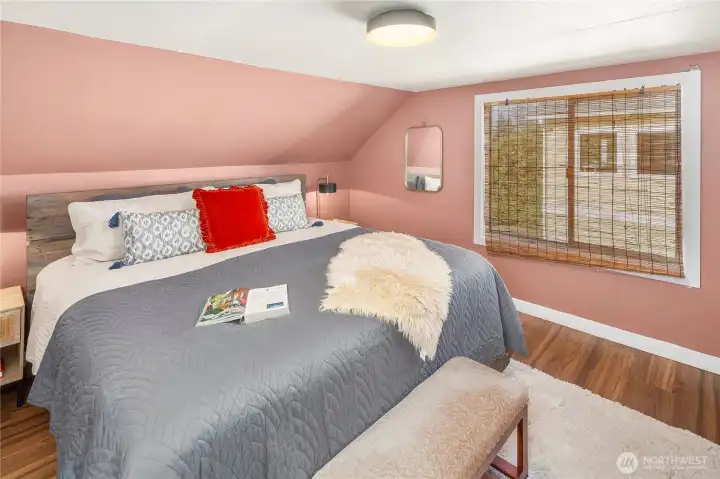 The warm and welcoming primary bedroom is spacious.