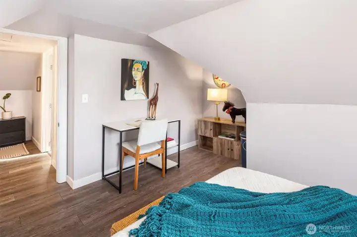 Another view of the space in the second upstairs bedroom. Note the durable laminate hardwoods.