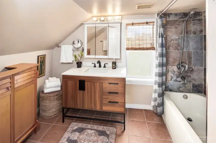 The full bathroom that sits upstairs, adjacent to the two bedrooms. Incredibly comfortable and sweet!