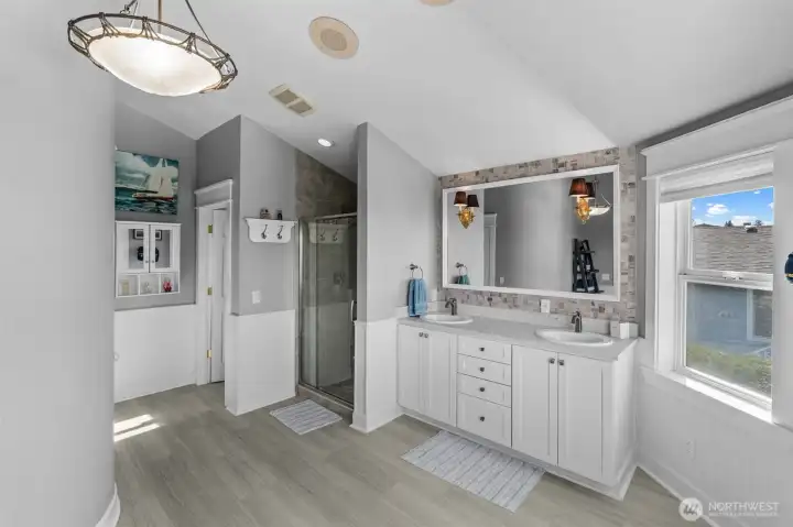 Primary bath with double sinks, walk-in, tiled shower and plumbed for tub.